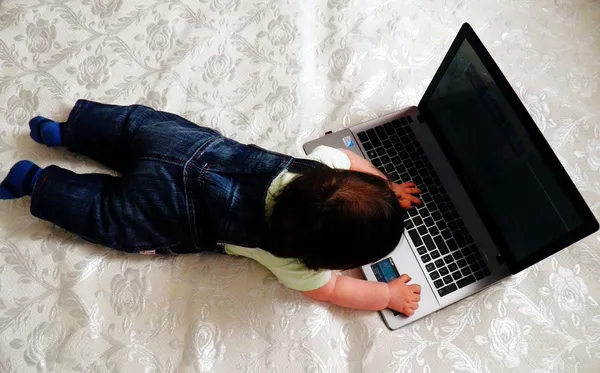 A baby's on a computer